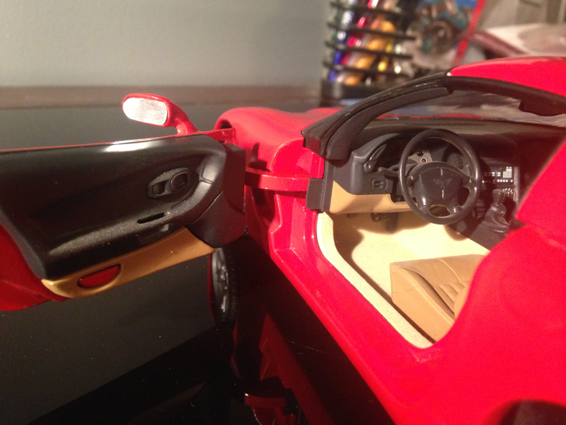 Interior has better detail and better textures than the Bburago. Center stack is molded and painted instead of a decal in the Bburago.